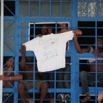 migrants expressing their protest against unbearable medical contitions: doctor not good, go to hell